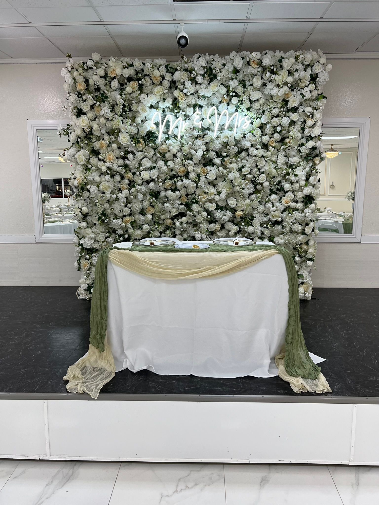 Sweetheart table with flower wall backdrop
